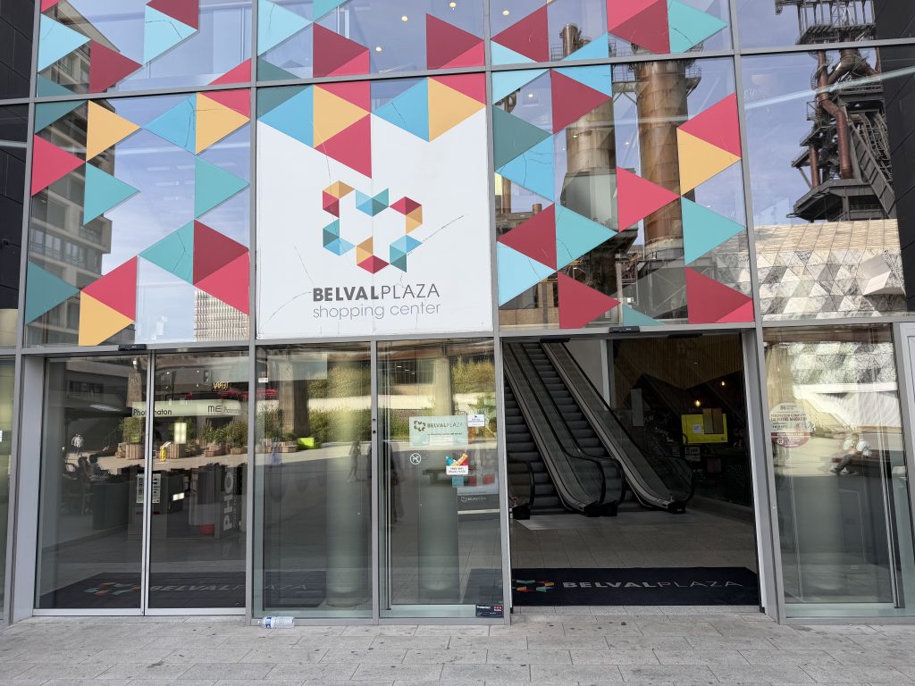The main entrance to Belval Plaza, with escalators behind the coloured glass façade