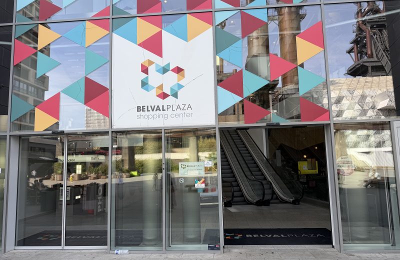The main entrance to Belval Plaza, with escalators behind the coloured glass façade