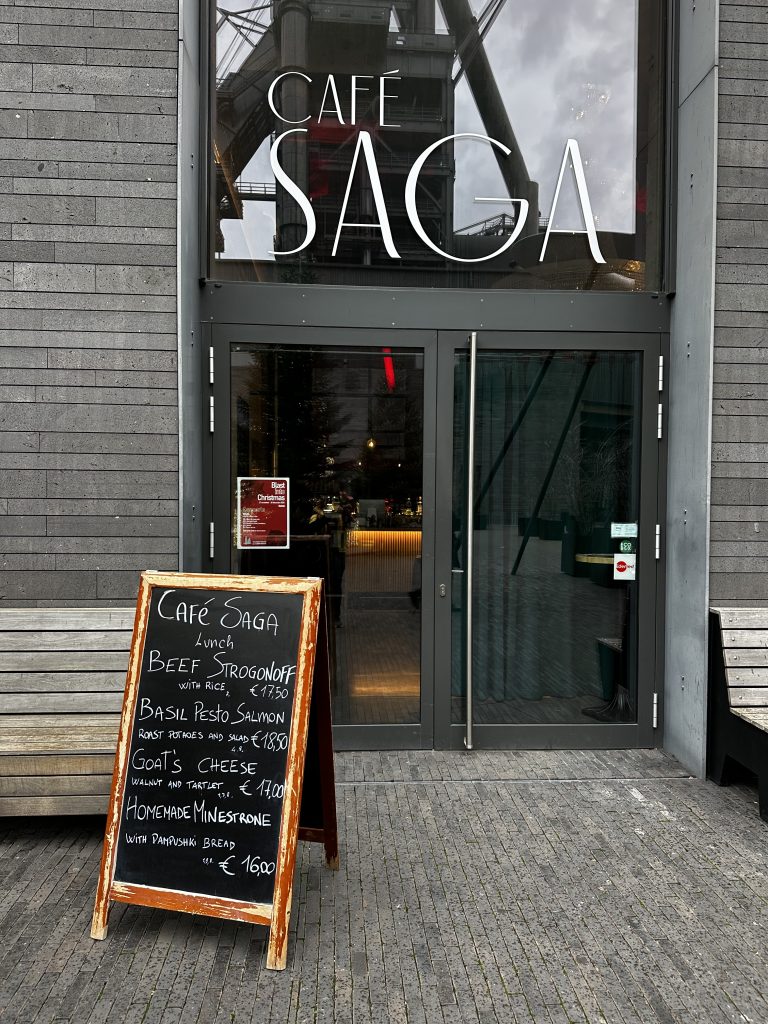 The interior of Café Saga, with the industrial roof structure above