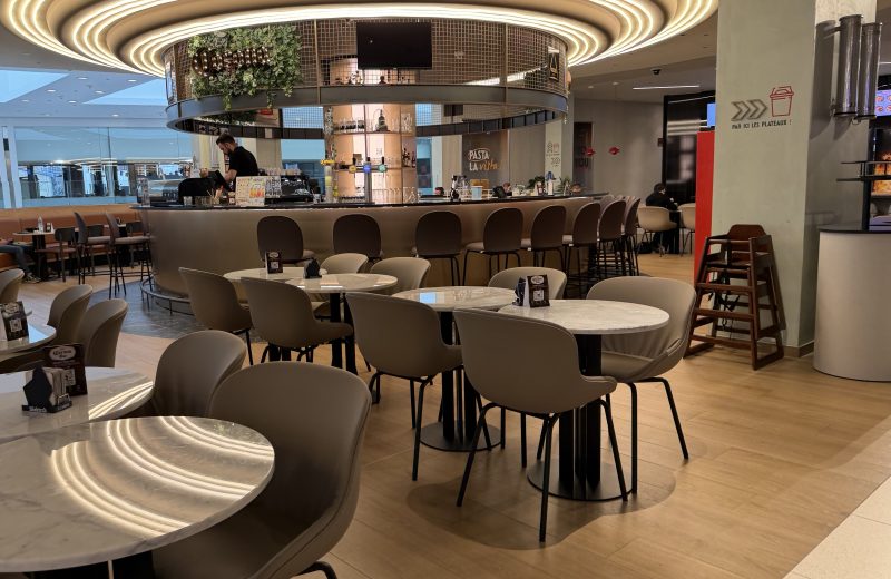 Inside Corona Bar in Belval, with a circular ceiling light above the tables