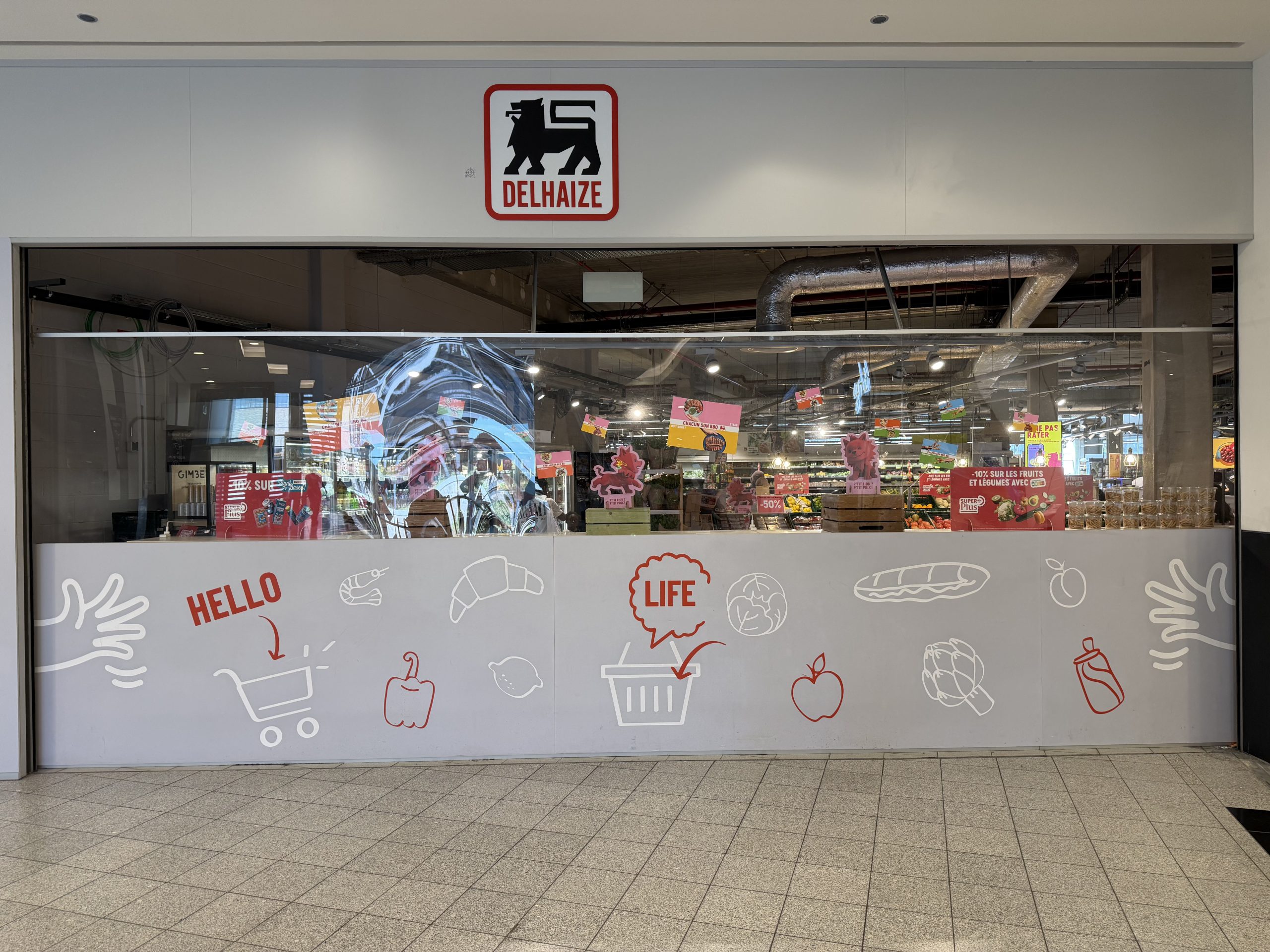 The Delhaize Belval entrance behind renovation hoarding in Belval Plaza