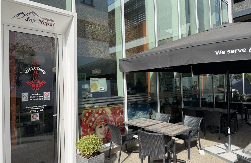 The Restaurant Jay Nepal frontage on Rue John Lennon, with tables outside