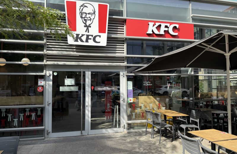 The KFC entrance in Belval, with its red signs and a terrace alongside