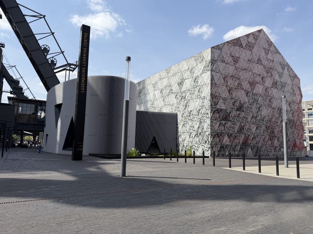 The Luxembourg Learning Centre in Belval, its patterned facade beside the industrial structures