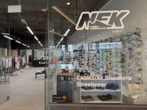 Inside New Fresh Kicks in Belval Plaza, with the sneaker wall behind the counter