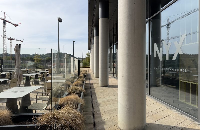 The Nyx terrace on Boulevard du Jazz in Belval, beside the glass frontage