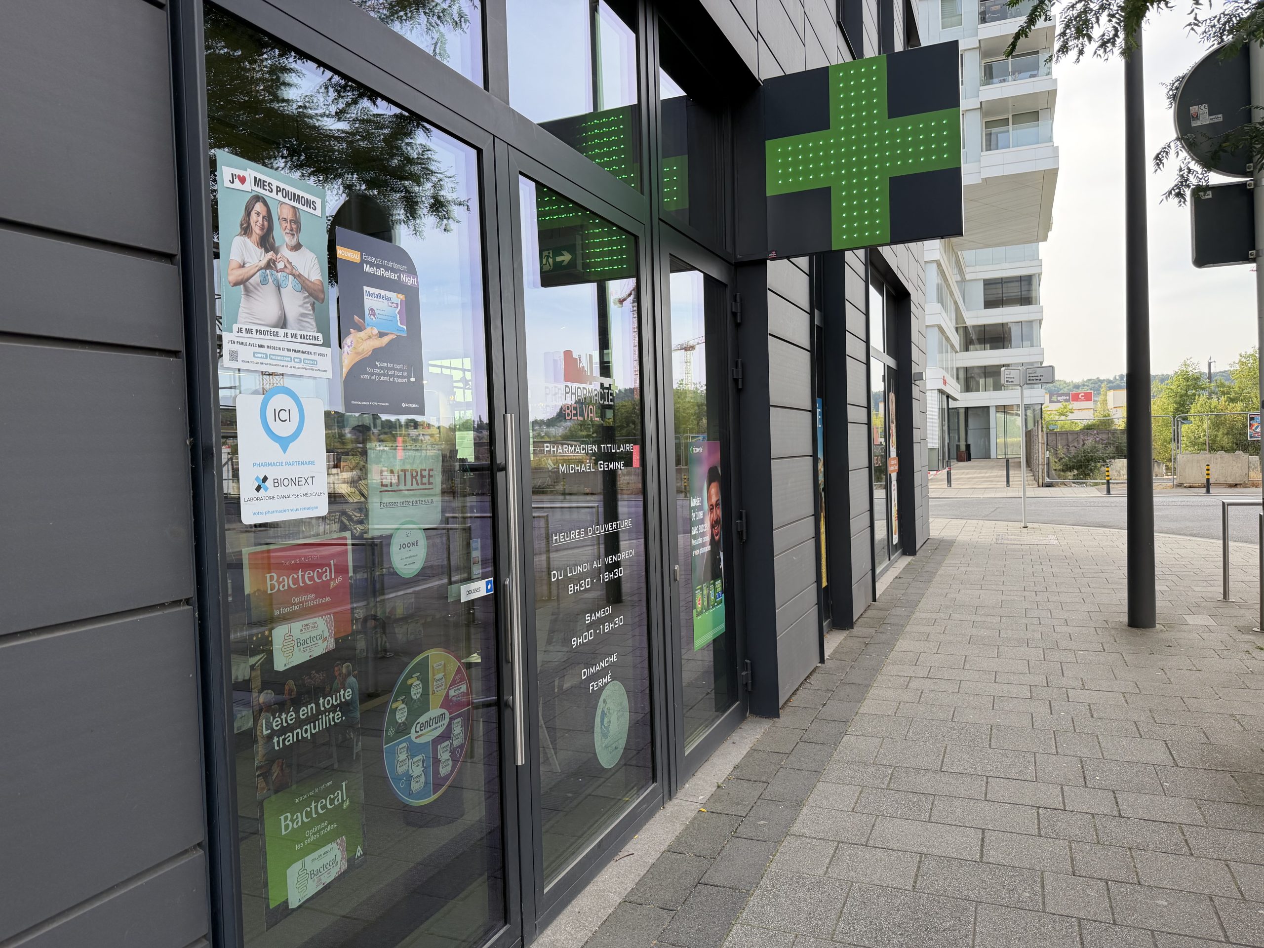 The Pharmacie de Belval shopfront on Avenue du Blues, with its green cross