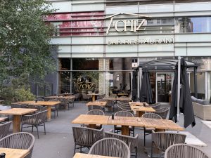 The Le T'Chiz terrace in Belval, with tables set out under the trees