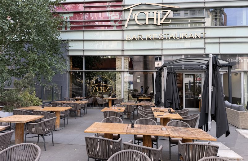 The Le T'Chiz terrace in Belval, with tables set out under the trees