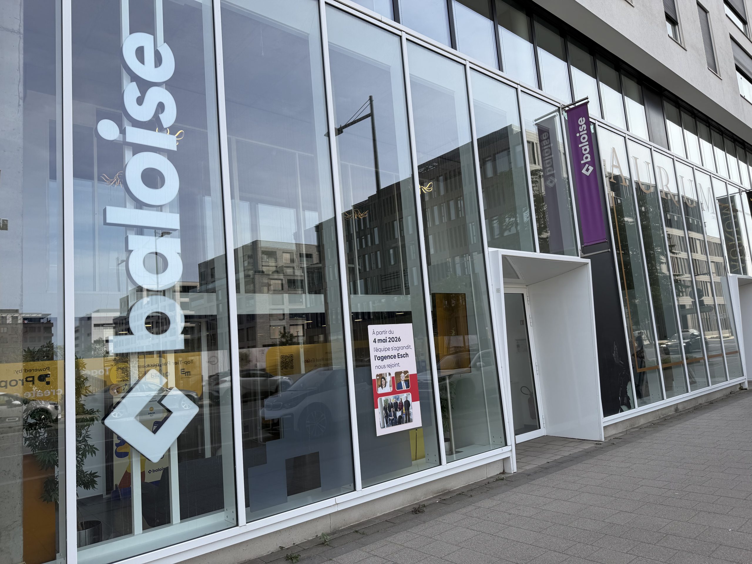 The Baloise insurance agency on boulevard du Jazz in Belval, with the Baloise name on the glass and a notice announcing that the Esch agency joined in May 2026.