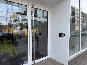The entrance to Belval Business Center at 11 boulevard du Jazz, with the company name and contact details on the glass door and an intercom beside it.