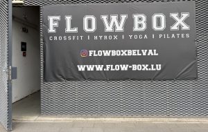 The FlowBox sign in Belval, listing CrossFit, Hyrox, yoga and Pilates