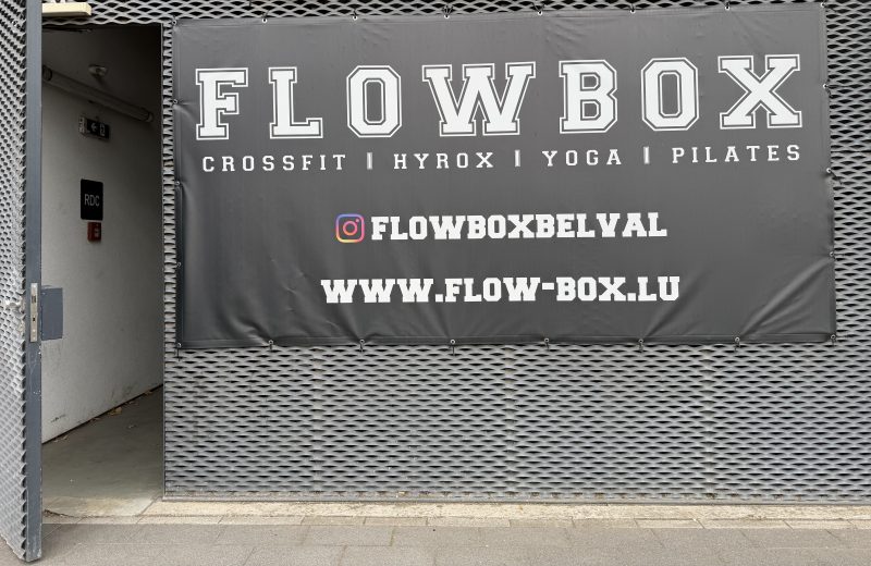 The FlowBox sign in Belval, listing CrossFit, Hyrox, yoga and Pilates