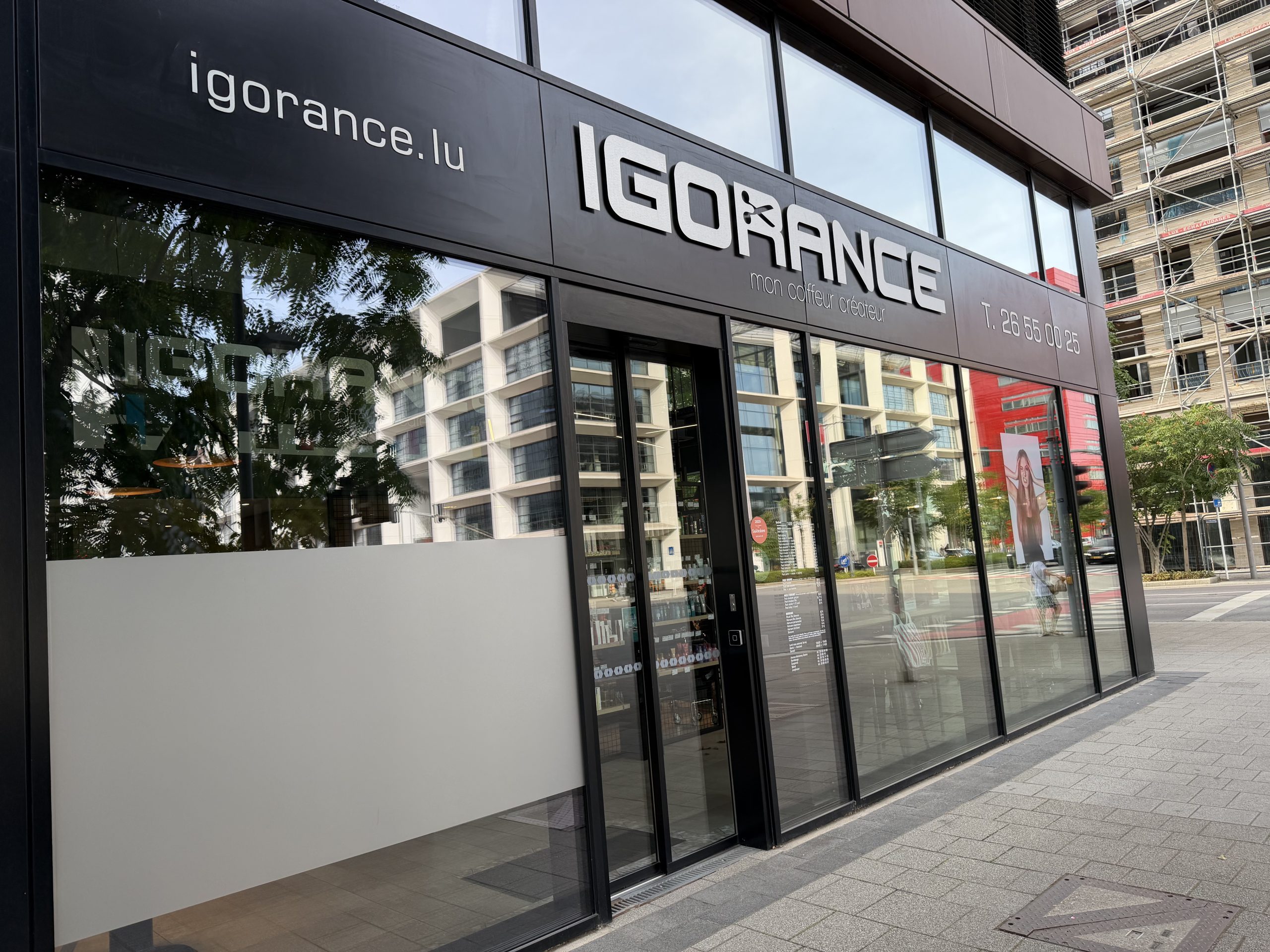 The Igorance hair salon on Porte de France in Belval, with its black fascia, the tagline mon coiffeur créateur and a price list displayed in the window.