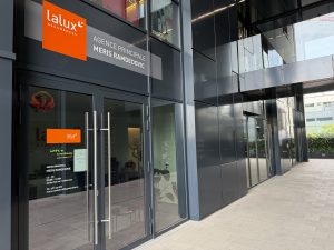 The lalux Assurances agency of Meris Ramdedovic at 9 boulevard du Jazz in Belval, with the orange lalux sign and a door decal listing opening hours and contact details.