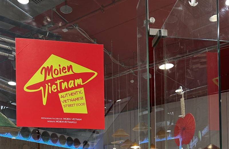 Moien Vietnam restaurant with it's logo on the glass door
