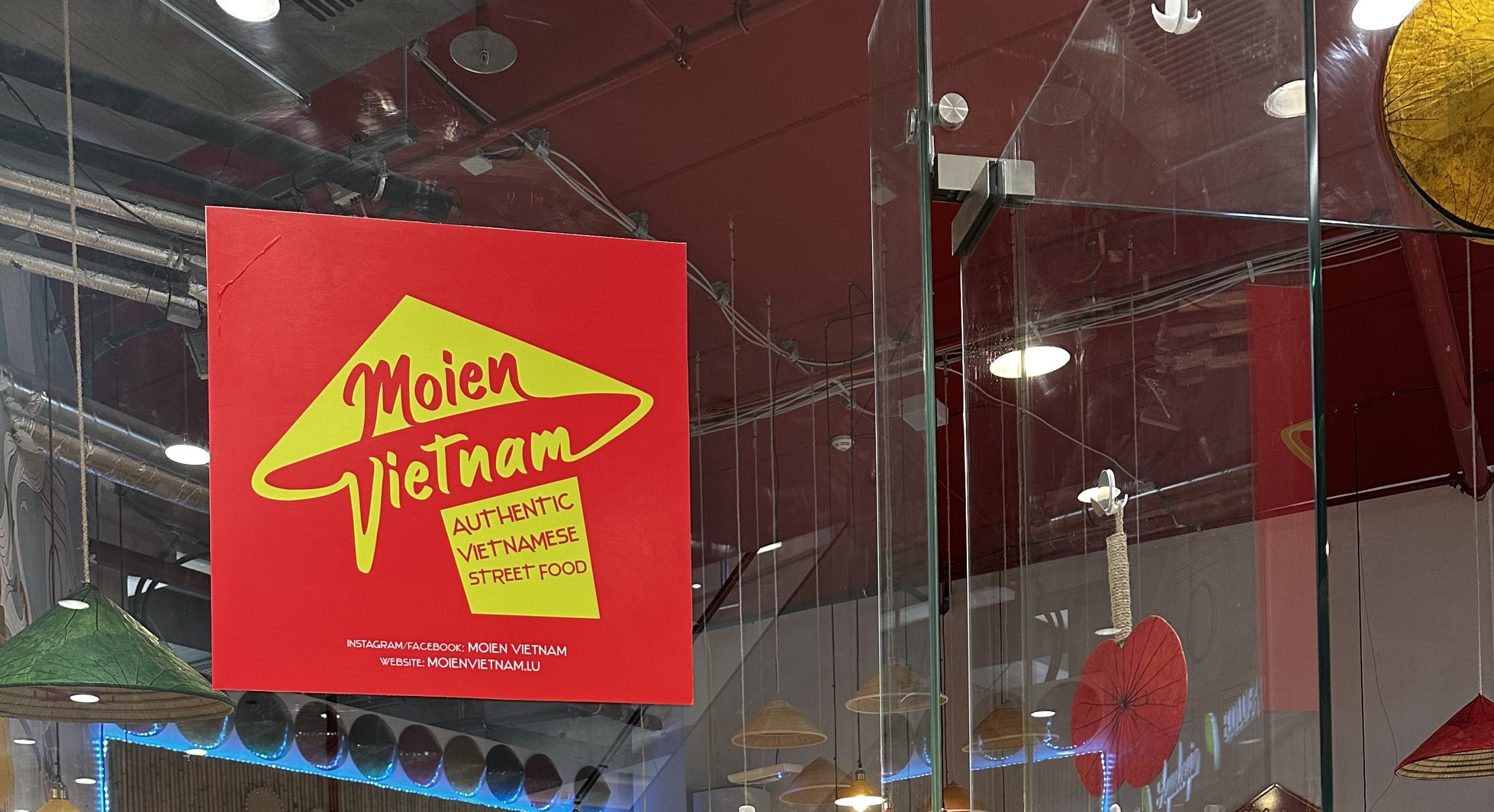 Moien Vietnam restaurant with it's logo on the glass door