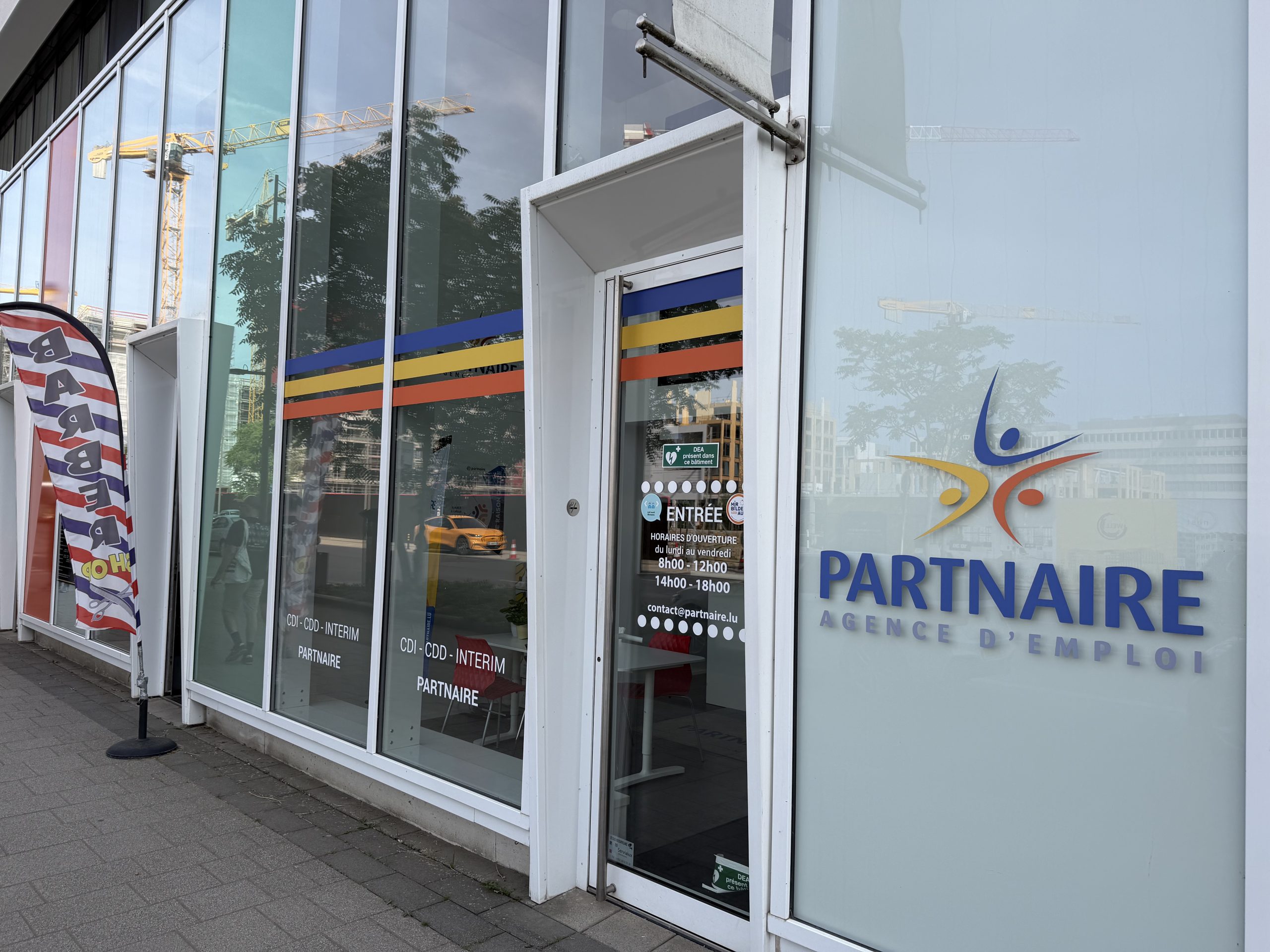 The Partnaire employment agency on boulevard du Jazz in Belval, with CDI, CDD and interim lettering on the window and opening hours on the entrance door.