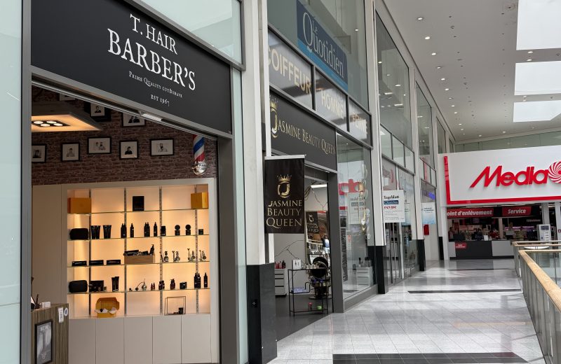 The T. Hair Barber's shopfront at Belval Plaza, dark fascia with the T. Hair Barber's lettering above the entrance.