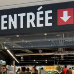 The Entrée sign and balloon columns at Delhaize Belval on the morning it reopened