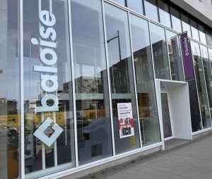 The Baloise insurance agency on boulevard du Jazz in Belval, with the Baloise name on the glass and a notice announcing that the Esch agency joined in May 2026.