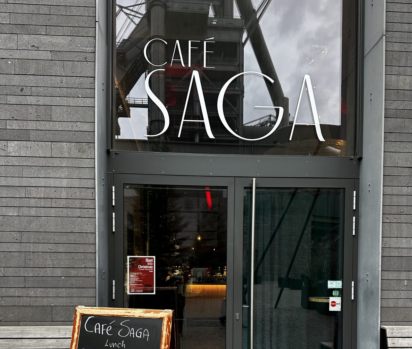 The Café Saga entrance in Belval, with a chalkboard menu outside