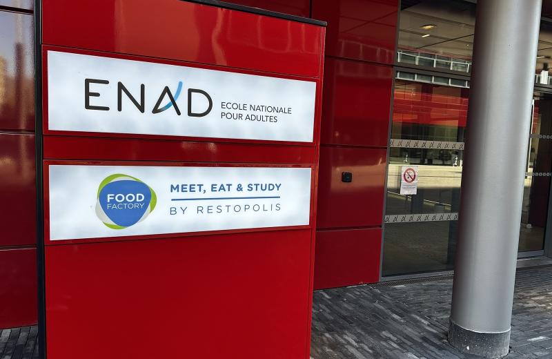 The red totem outside ENAD in Belval carrying the school’s name above the Food Factory logo and the Restopolis strapline.