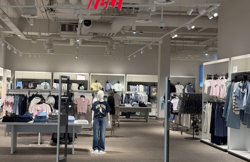 Inside the H&M store in Belval Plaza, with clothing rails under the H&M sign