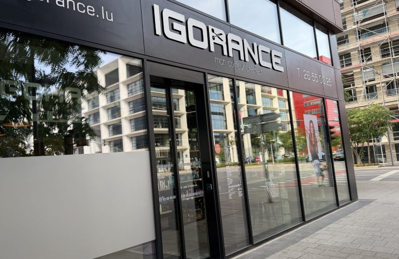 The Igorance hair salon on Porte de France in Belval, with its black fascia, the tagline mon coiffeur créateur and a price list displayed in the window.