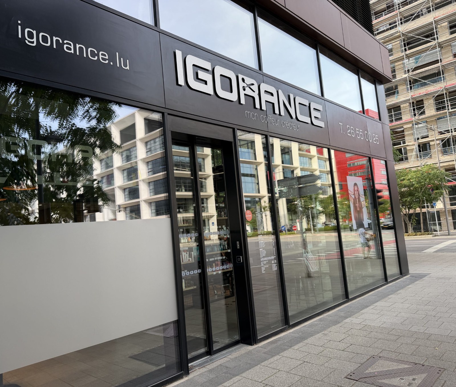 The Igorance hair salon on Porte de France in Belval, with its black fascia, the tagline mon coiffeur créateur and a price list displayed in the window.