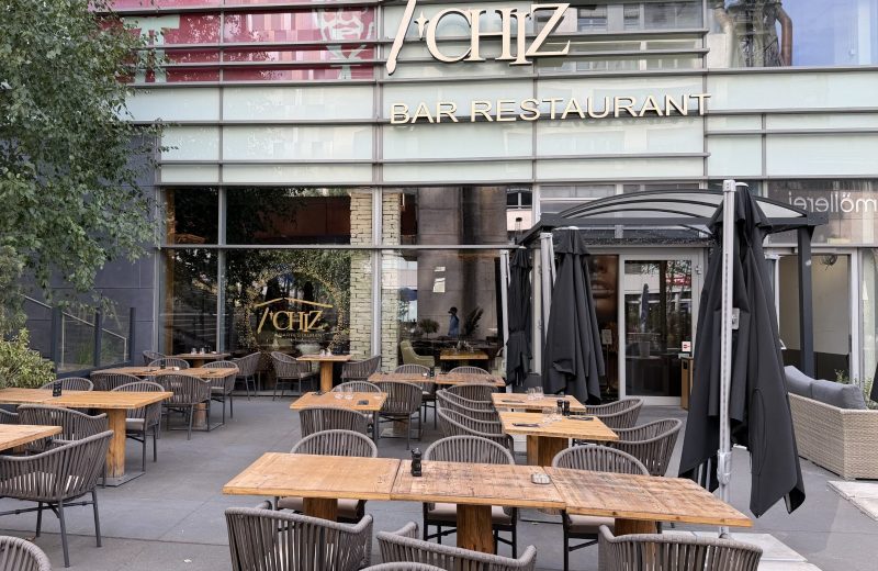 The Le T'Chiz terrace in Belval, with tables set out under the trees