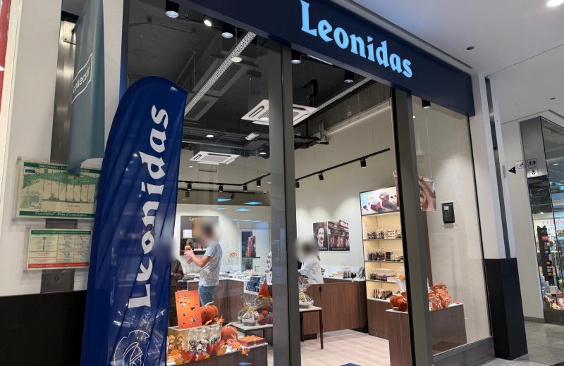 The Leonidas shopfront in Belval Plaza, autumn chocolates in the window and the counter in view.