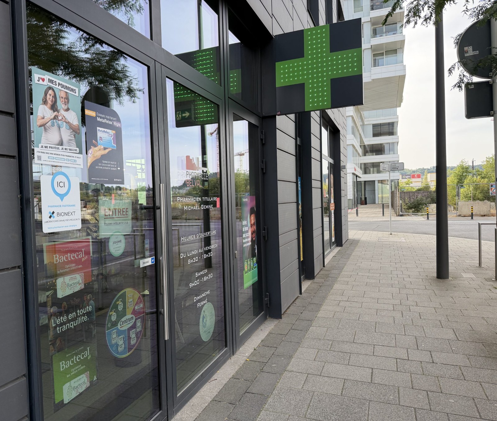 The Pharmacie de Belval shopfront on Avenue du Blues, with its green cross