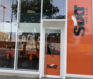The Sixt car hire branch on boulevard du Jazz in Belval, with the orange Sixt frontage and a key return box beside the door.