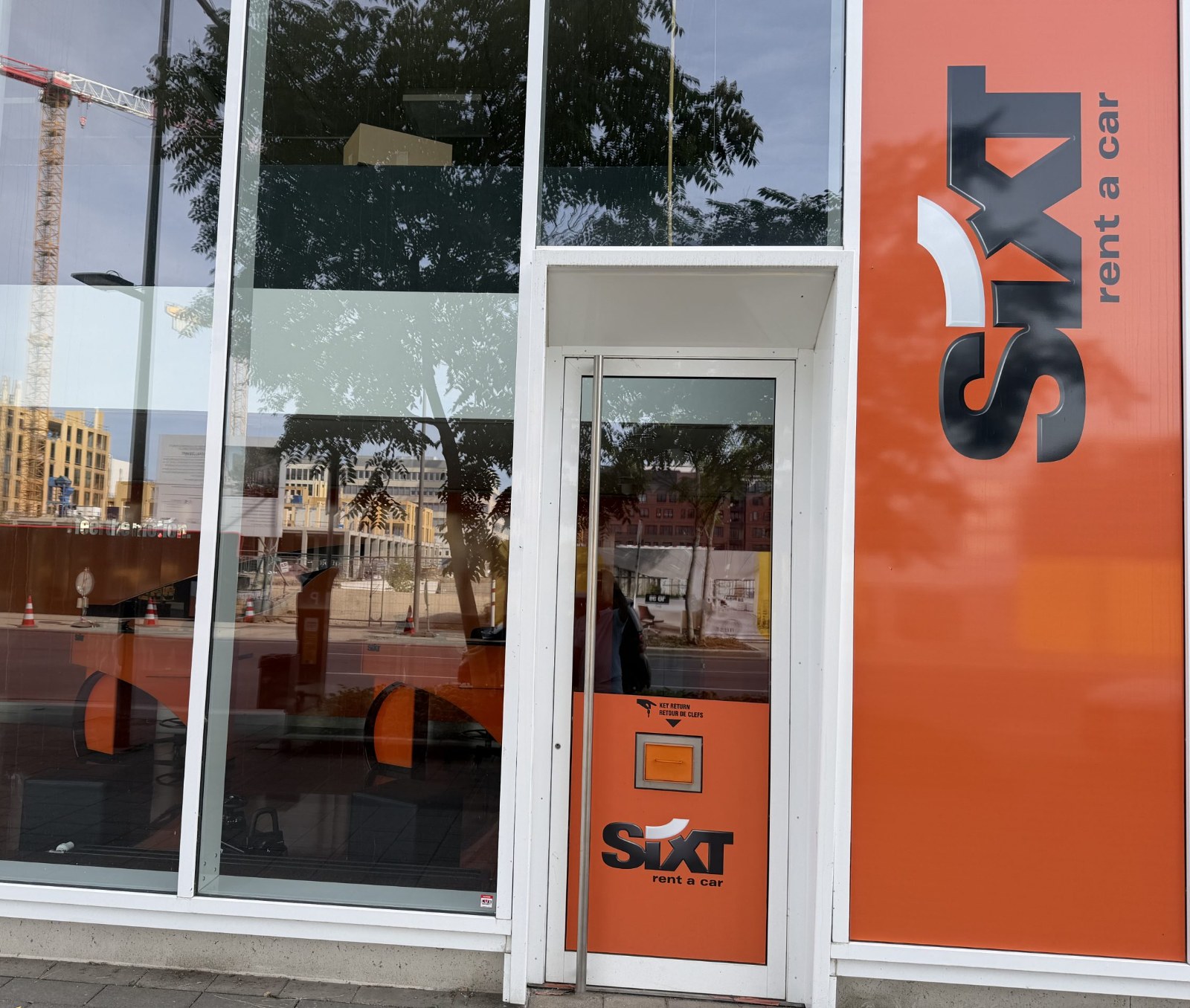 The Sixt car hire branch on boulevard du Jazz in Belval, with the orange Sixt frontage and a key return box beside the door.